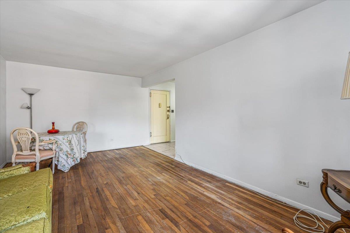 144-55 Melbourne Avenue, Unit 3J Queens, NY 11367 - Photo 5 of 13 Living area with baseboards and light wood-style flooring