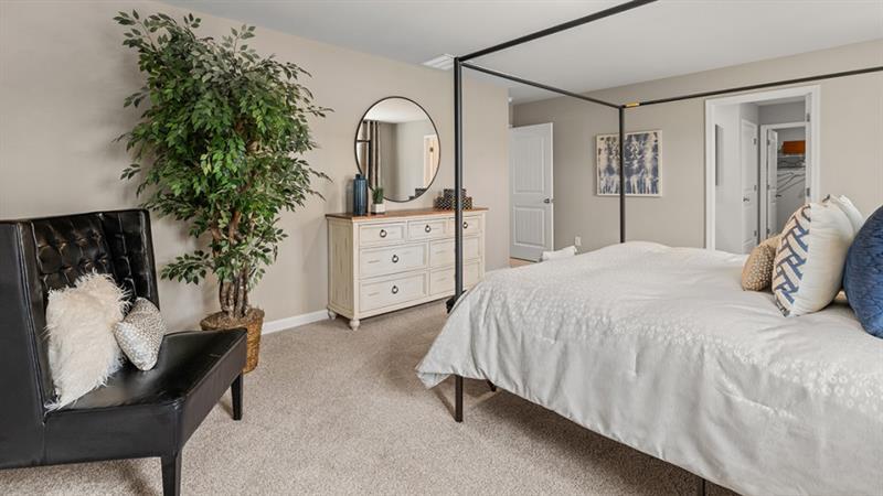 74 Buckthorn Way Dallas, GA 30132 - Photo 17 of 37 a bedroom with a bed and a mirror on dresser
