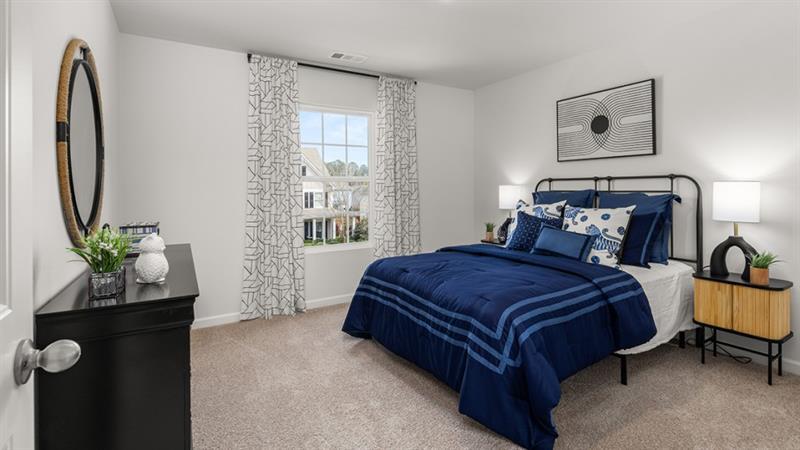 74 Buckthorn Way Dallas, GA 30132 - Photo 28 of 37 a bedroom with a bed and a potted plant