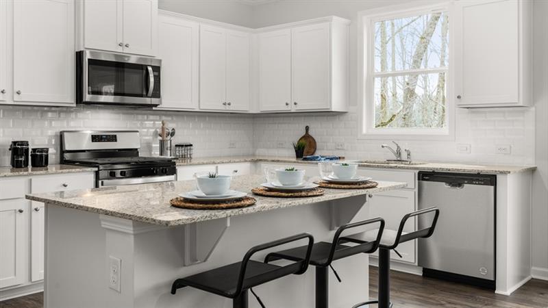 74 Buckthorn Way Dallas, GA 30132 - Photo 3 of 37 a kitchen with stainless steel appliances granite countertop a stove a sink a microwave and cabinets