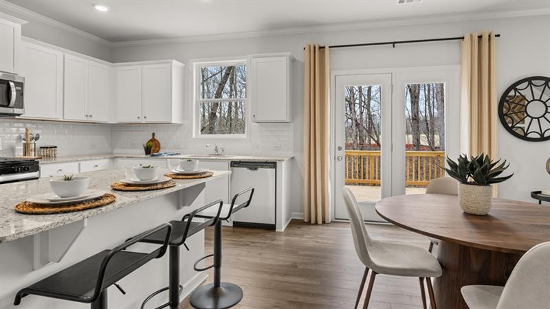 74 Buckthorn Way Dallas, GA 30132 - Photo 4 of 37 a kitchen with stainless steel appliances a dining table and chairs
