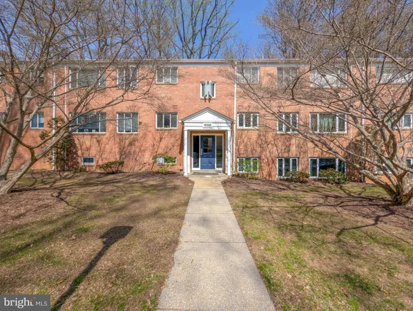 a front view of a building with a yard