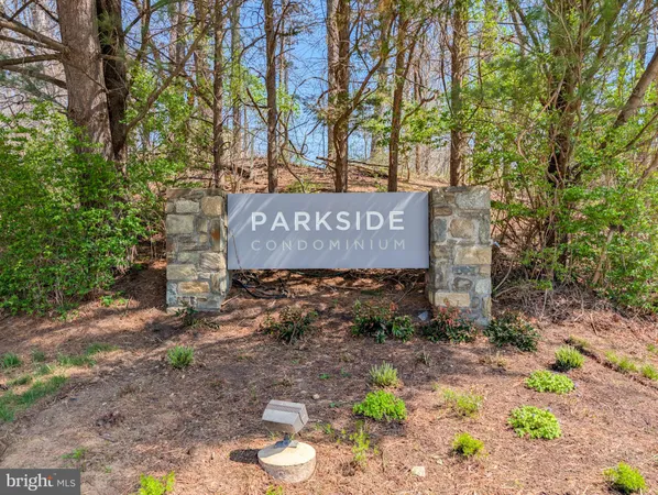 a sign that is sitting in the middle of forest