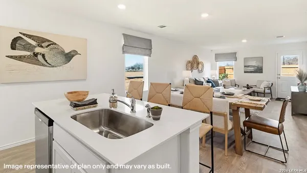 a kitchen with a sink a table and chairs