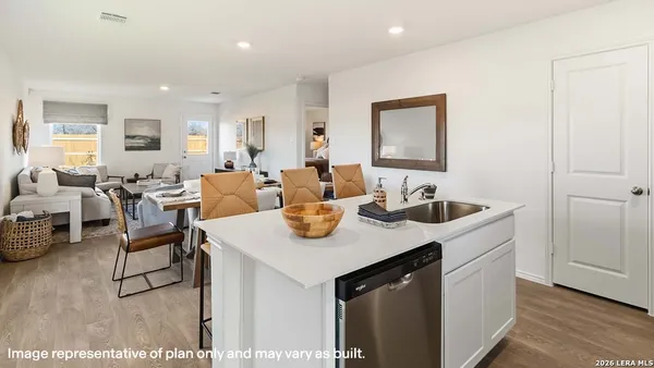 a view of a kitchen area with furniture and wooden floor