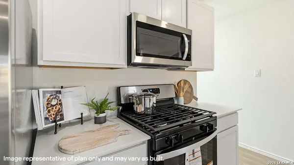 a kitchen with a stove and a microwave