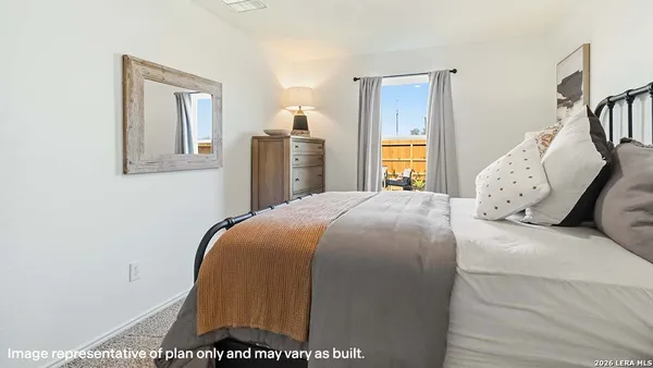 a bed sitting in a bedroom next to a window