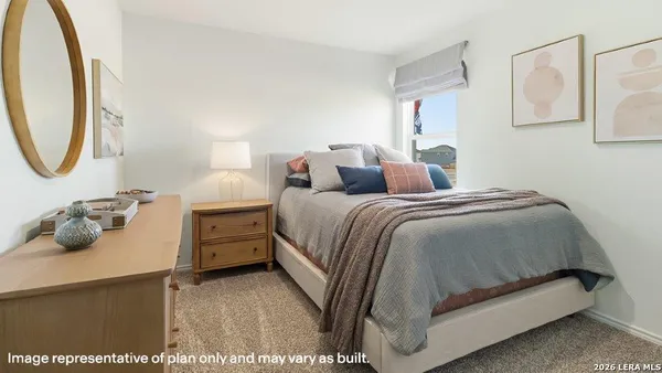 a bedroom with a bed and a mirror