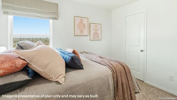 a bedroom with a bed and a night stand