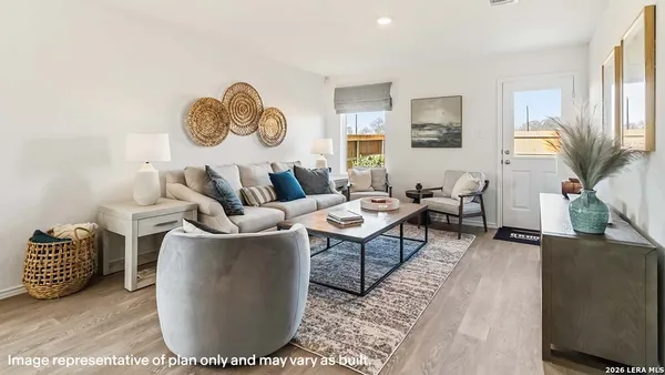 a living room with couch chairs and a window