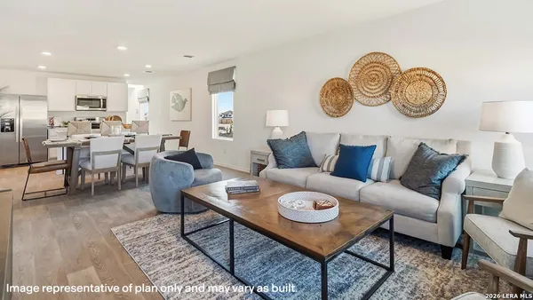 a living room with furniture a rug and a window