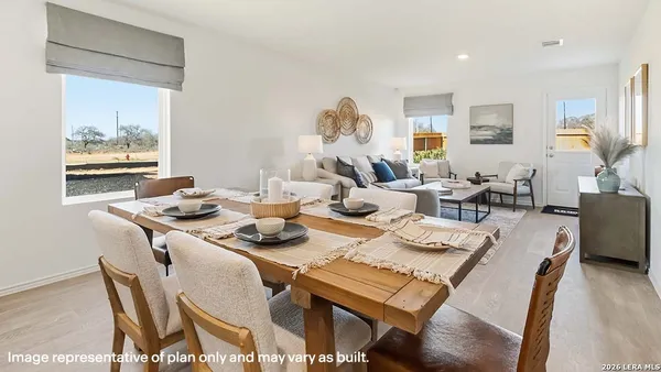 a dining room with furniture wooden floor and a rug