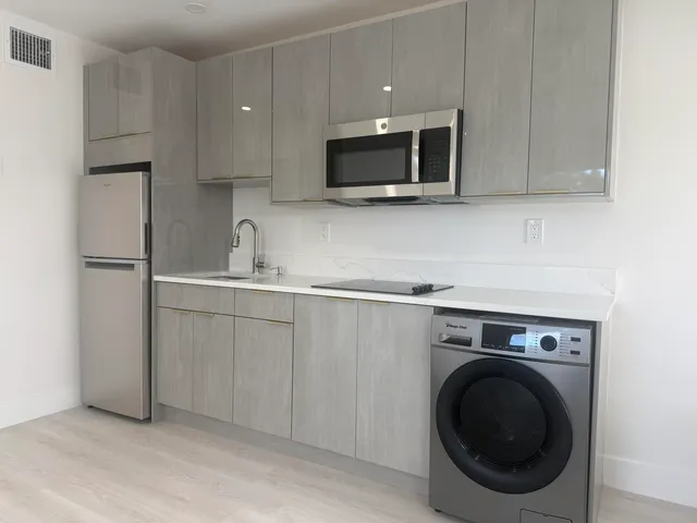 a kitchen with a sink and a microwave