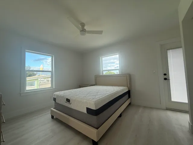 a bed sitting in a bedroom next to a window