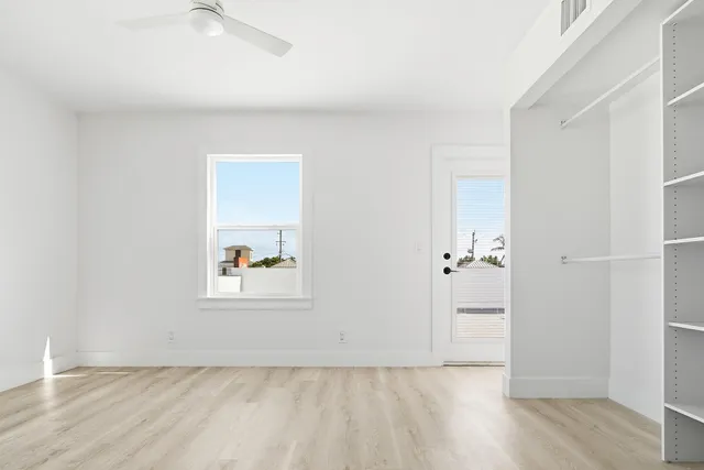 an empty room with a door and wooden floor