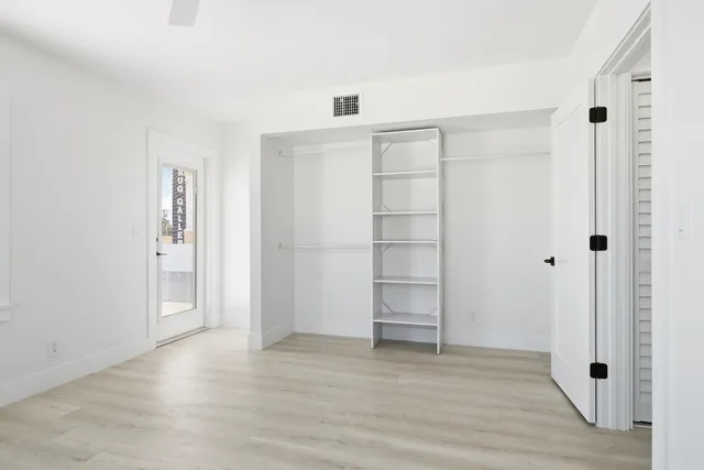 a view of staircase with lots of frames on wall and a potted plant