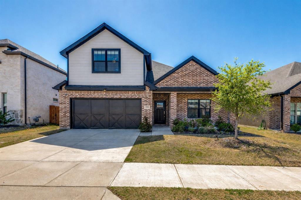 332 Braves Way Lavon, TX 75166 - Photo 1 of 24 a front view of a house with a yard and garage