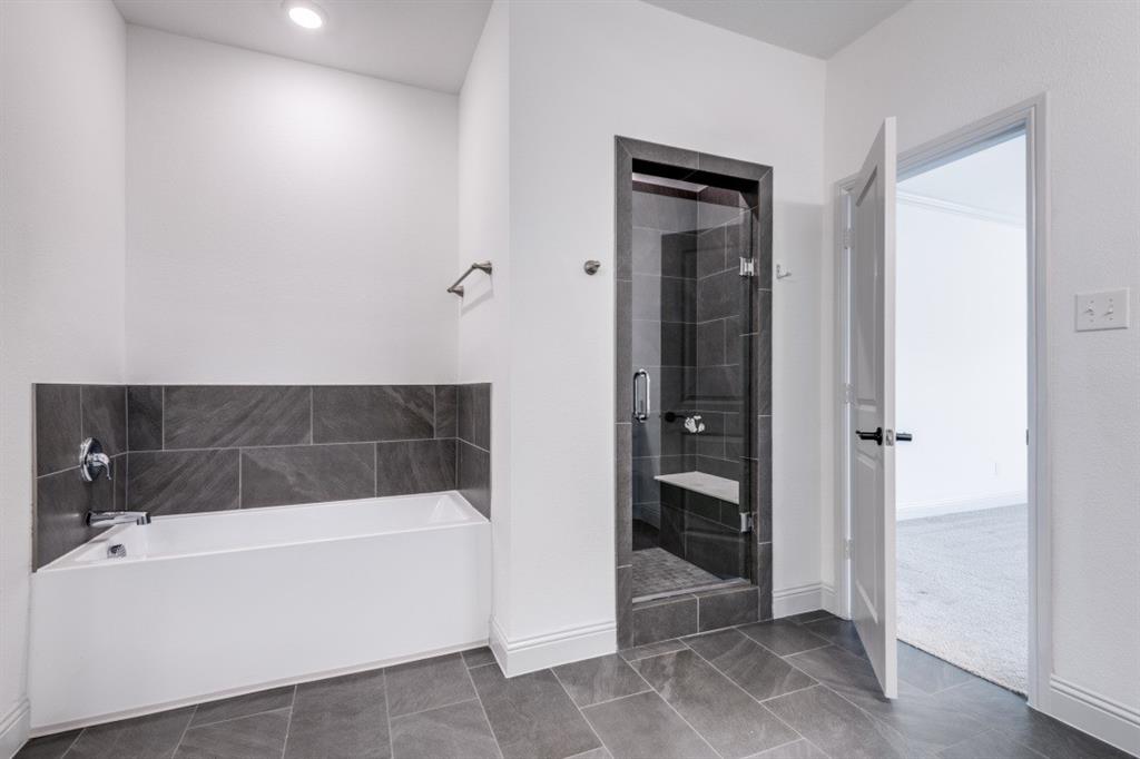 332 Braves Way Lavon, TX 75166 - Photo 11 of 24 a bathroom with a bathtub and a shower