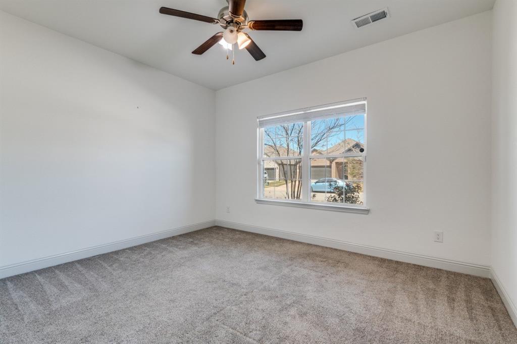 332 Braves Way Lavon, TX 75166 - Photo 15 of 24 a view of an empty room with a window and a ceiling fan