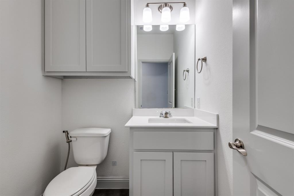 332 Braves Way Lavon, TX 75166 - Photo 16 of 24 a bathroom with a toilet sink and mirror