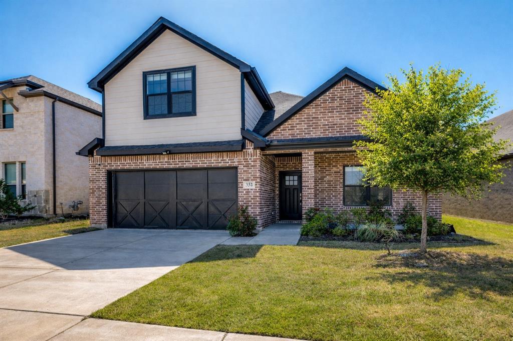 332 Braves Way Lavon, TX 75166 - Photo 2 of 24 a front view of a house with a yard and garage
