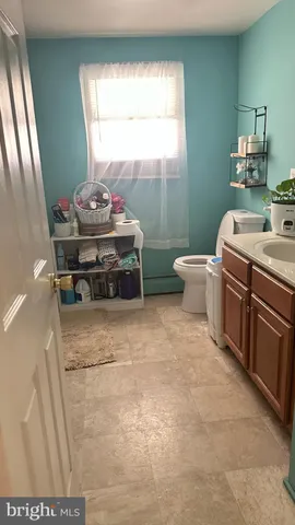 a bathroom with a toilet sink and mirror