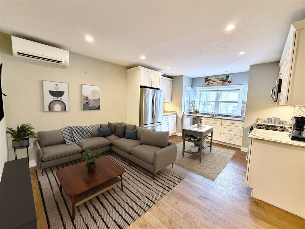 a living room with furniture or couch and a wooden floor