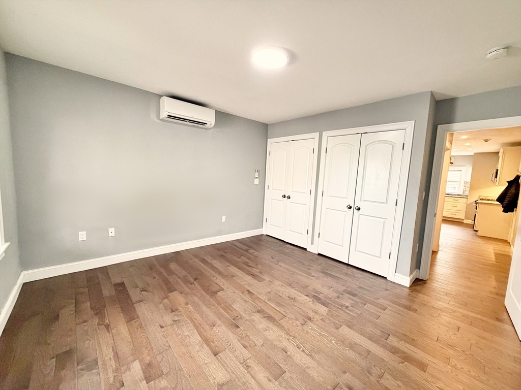 266 Lexington Street, Unit 1 Boston, MA 02128 - Photo 12 of 19 a view of an empty room and wooden floor