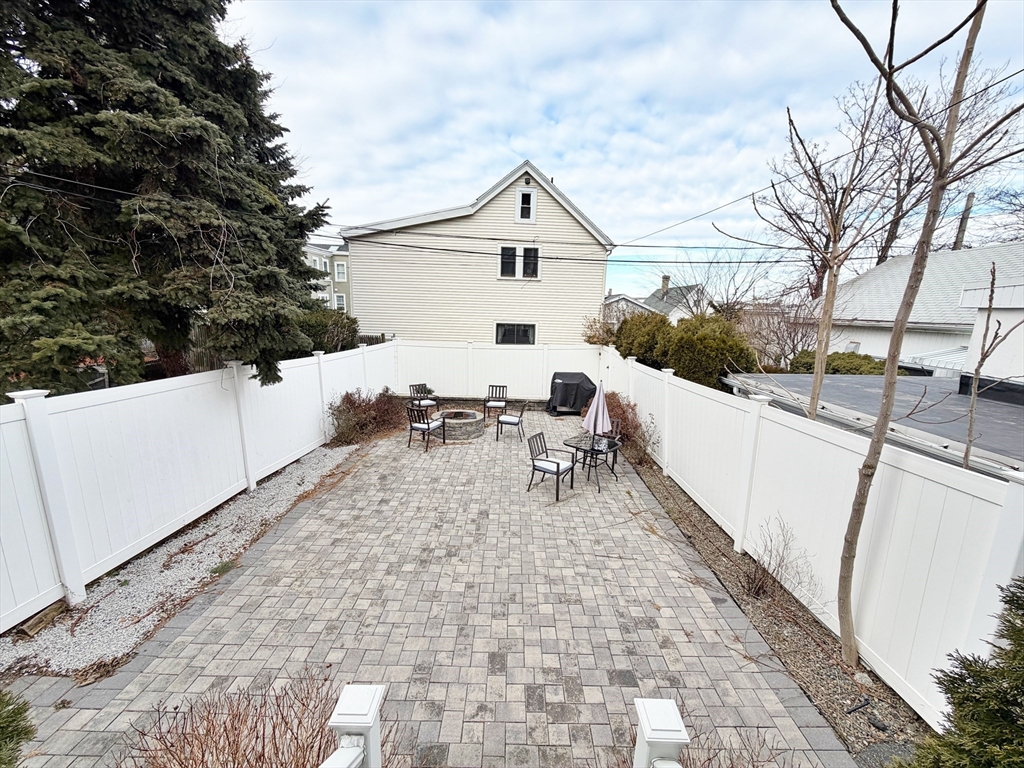 266 Lexington Street, Unit 1 Boston, MA 02128 - Photo 18 of 19 a view of a terrace with chairs and wooden fence