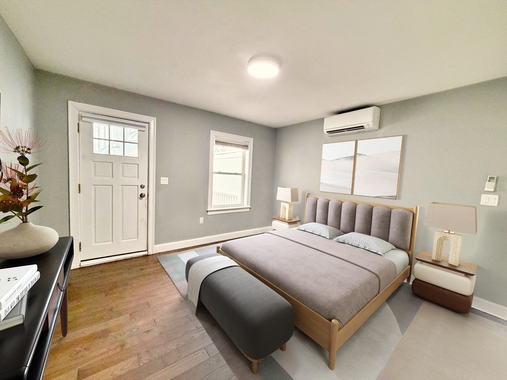 266 Lexington Street, Unit 1 Boston, MA 02128 - Photo 3 of 19 a bedroom with a bed a table and chair