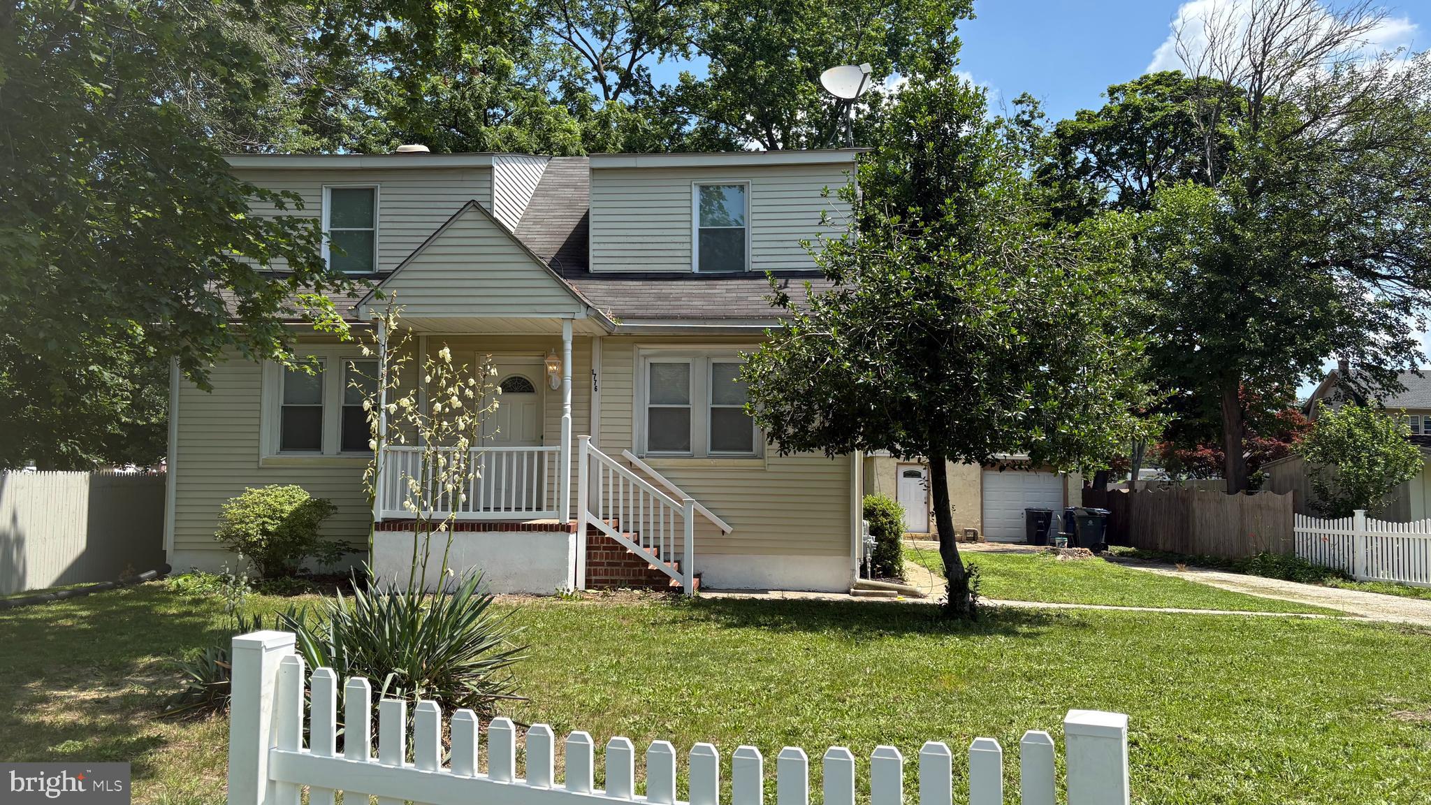 a view of a house with backyard and a tree