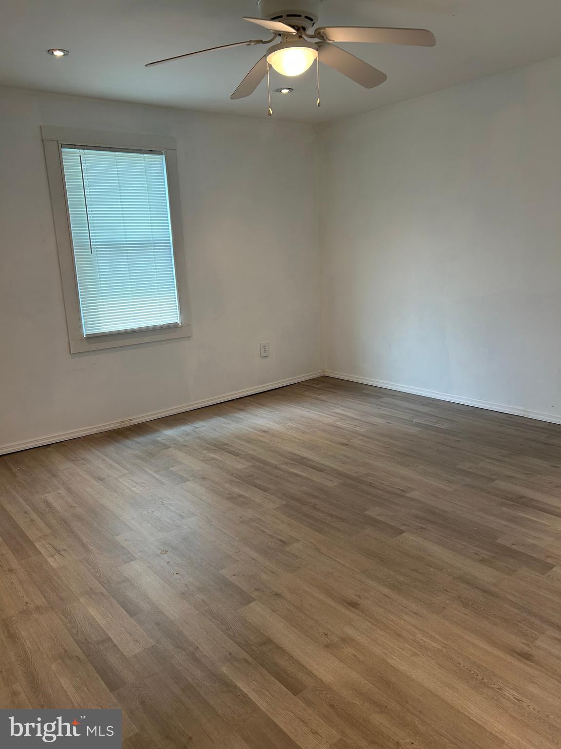 1776 North Tuckahoe Road Williamstown, NJ 08094 - Photo 8 of 14 an empty room with wooden floor and windows