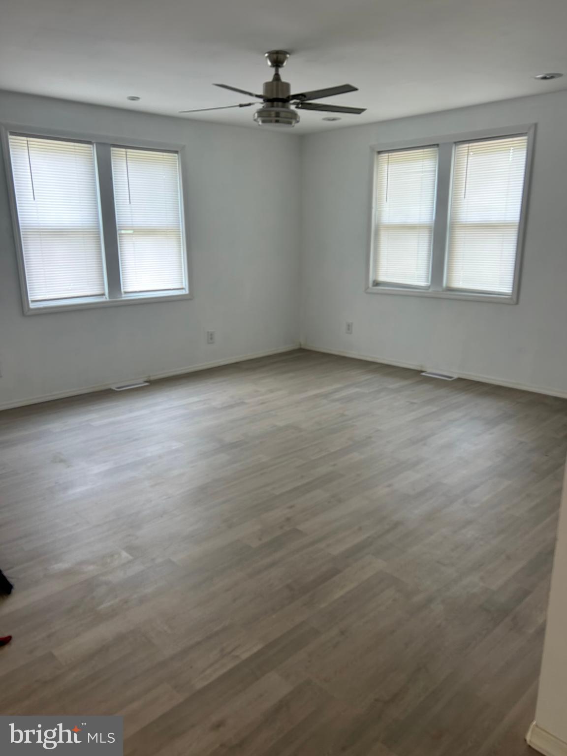 1776 North Tuckahoe Road Williamstown, NJ 08094 - Photo 10 of 14 an empty room with windows and ceiling fan