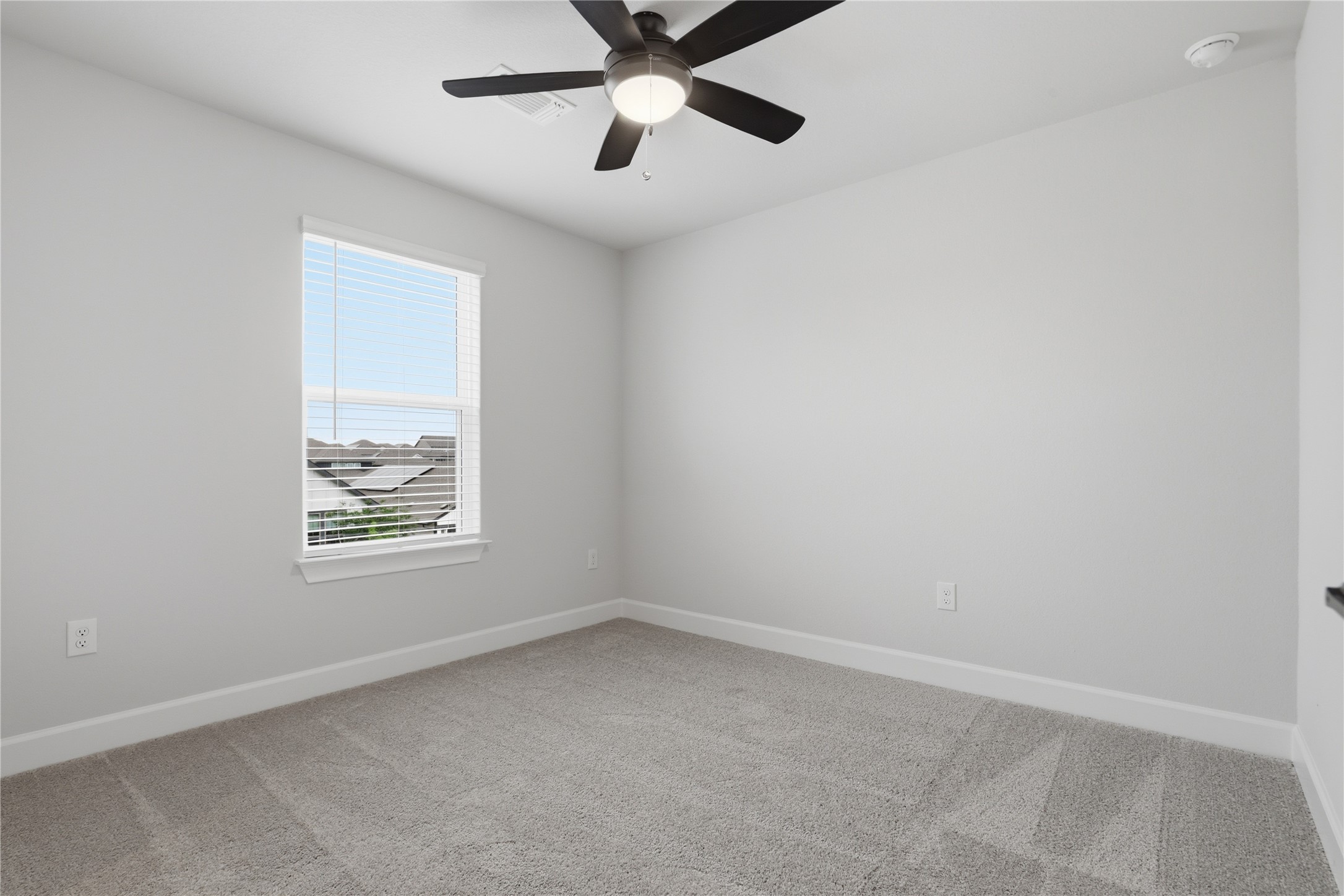 9320 Gladsome Path Manor, TX 78653 - Photo 17 of 34 an empty room with a window and a fan