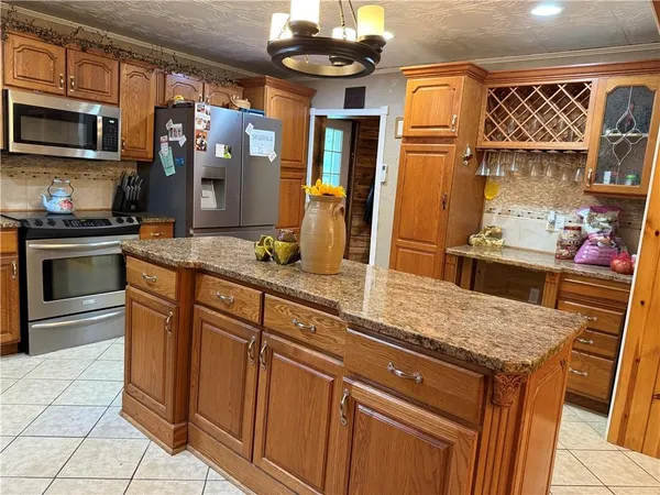 a kitchen with stainless steel appliances granite countertop a sink and a stove