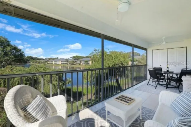 a balcony with table and chairs