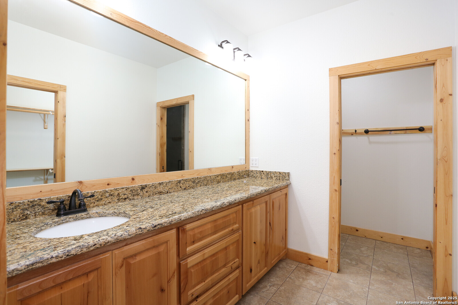 891 Hopkinsville Road Cuero, TX 77954 - Photo 11 of 36 a bathroom with a granite countertop sink and a mirror