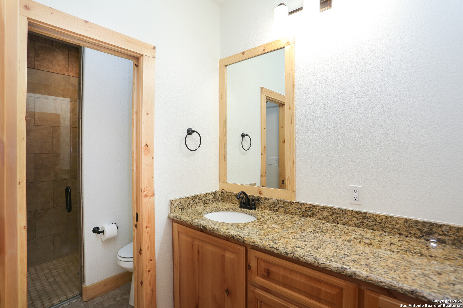891 Hopkinsville Road Cuero, TX 77954 - Photo 16 of 36 a bathroom with a granite countertop sink and a mirror