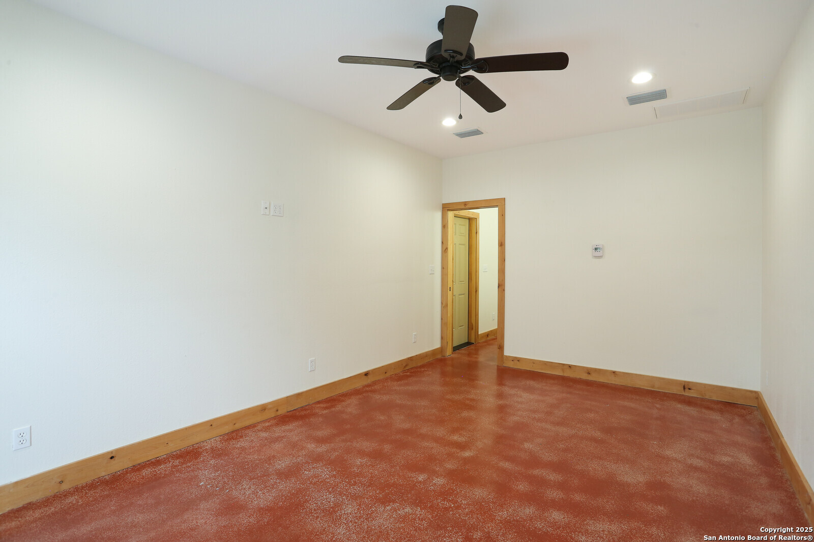 891 Hopkinsville Road Cuero, TX 77954 - Photo 27 of 36 an empty room with a ceiling fan and carpet