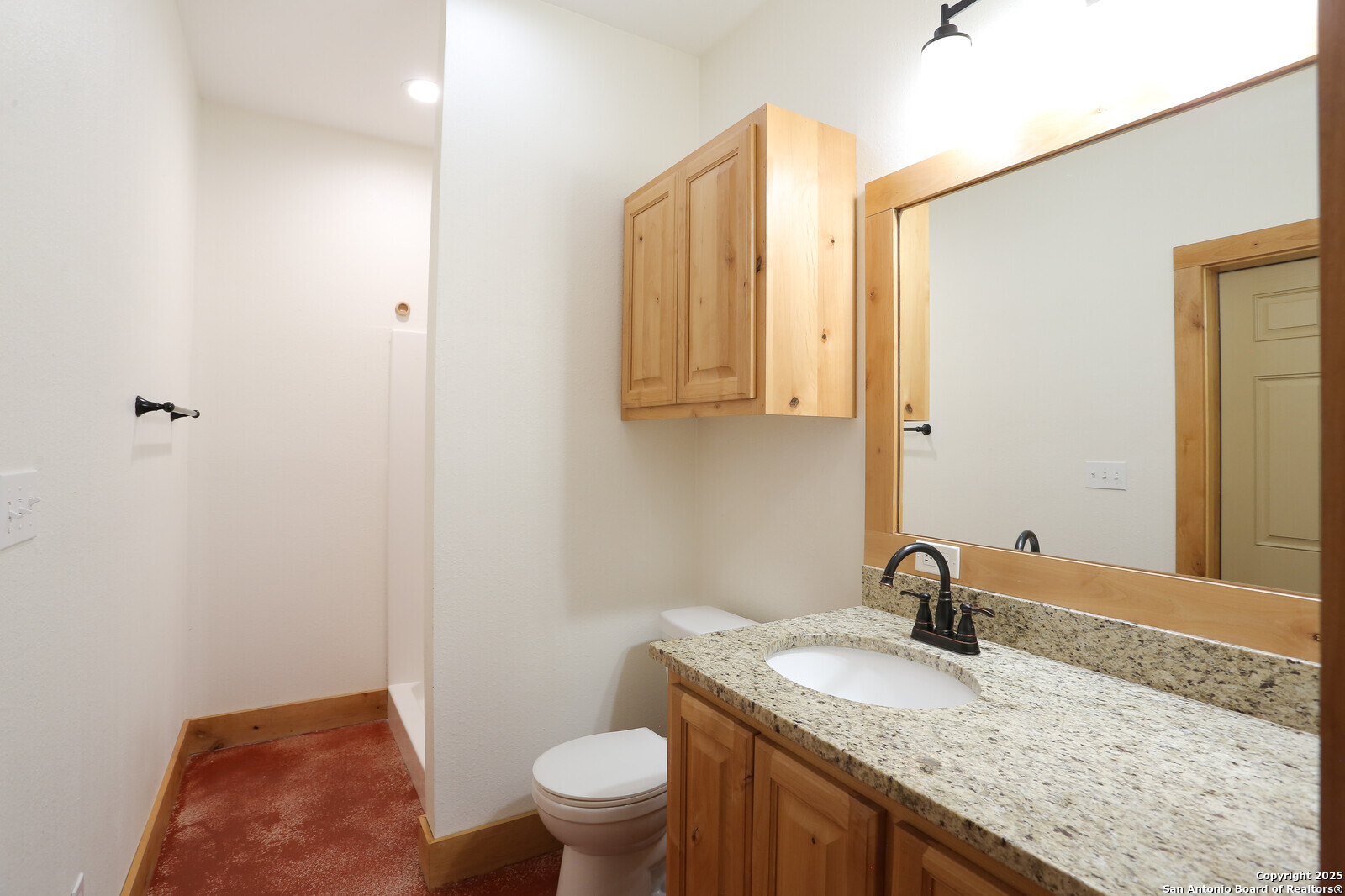 891 Hopkinsville Road Cuero, TX 77954 - Photo 28 of 36 a bathroom with a granite countertop sink a toilet and mirror