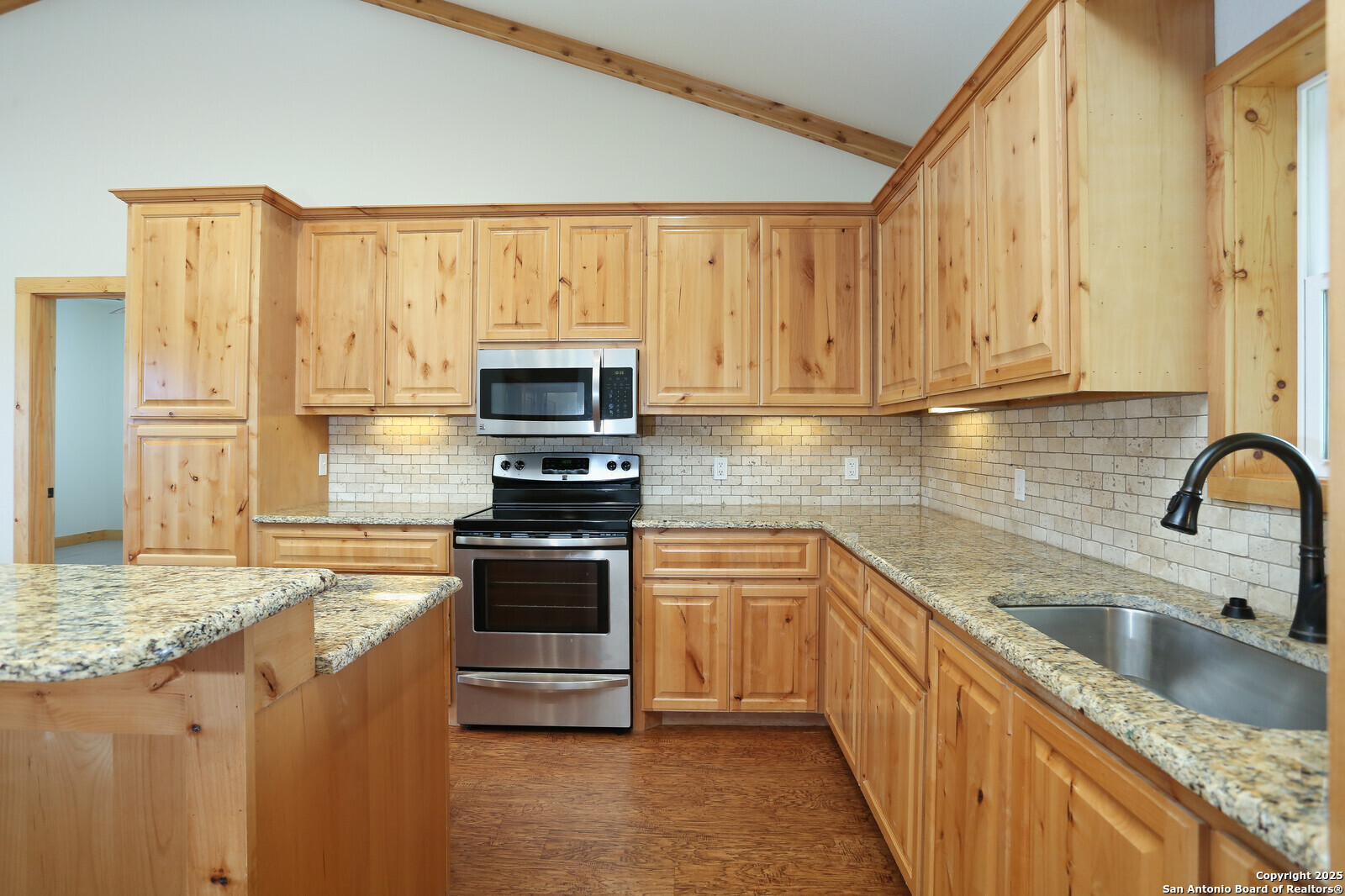 891 Hopkinsville Road Cuero, TX 77954 - Photo 7 of 36 a kitchen with stainless steel appliances granite countertop a stove a sink and a microwave