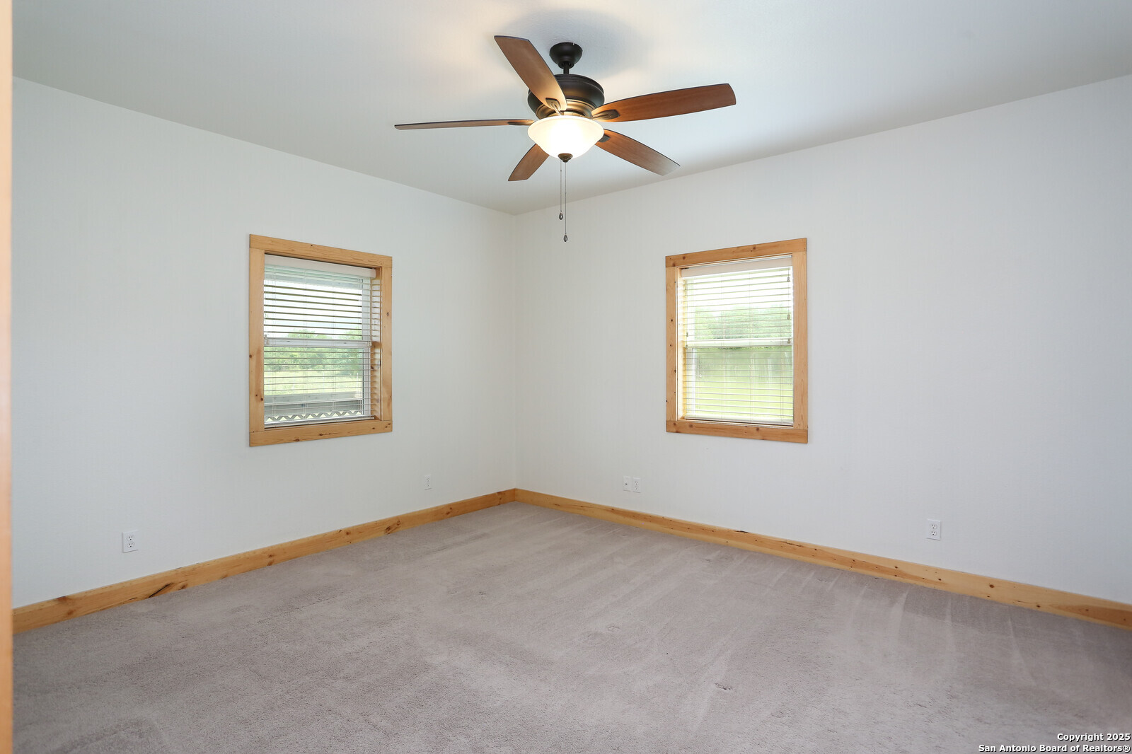 891 Hopkinsville Road Cuero, TX 77954 - Photo 9 of 36 an empty room with a window and a ceiling fan