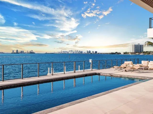 a living room with patio furniture and a potted plant