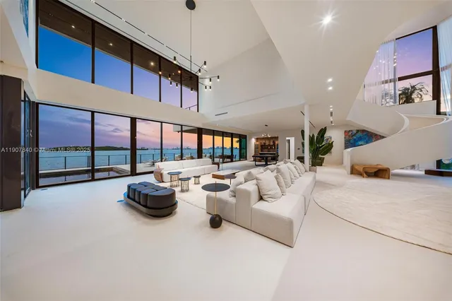 a living room with lots of furniture and a chandelier