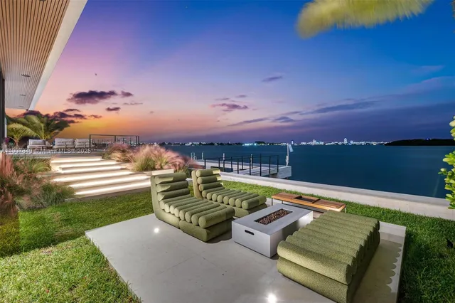 a living room with lots of furniture and kitchen view