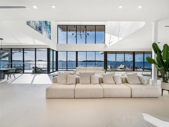 a bedroom with a large window and a flat screen tv