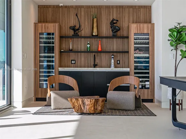 a view of an empty room with wooden floor and windows
