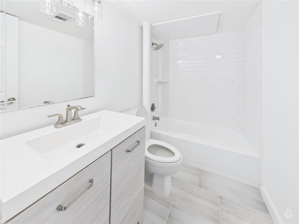 2020 South Congress Avenue, Unit 1209 Austin, TX 78704 - Photo 8 of 16 a bathroom with a sink a toilet and shower