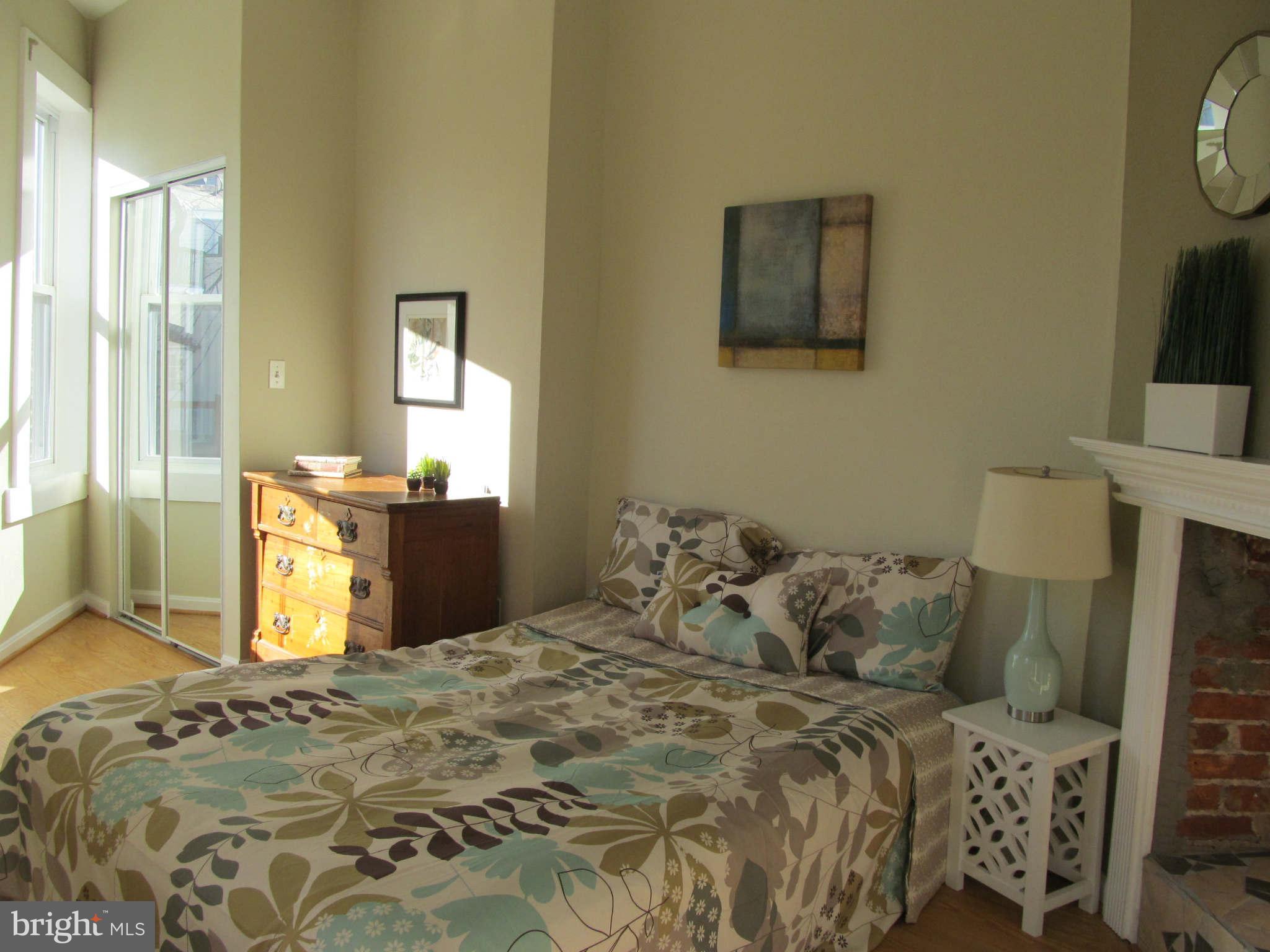 1908 6th Street Northwest Washington, DC 20001 - Photo 20 of 30 a bedroom with a bed and a mirror