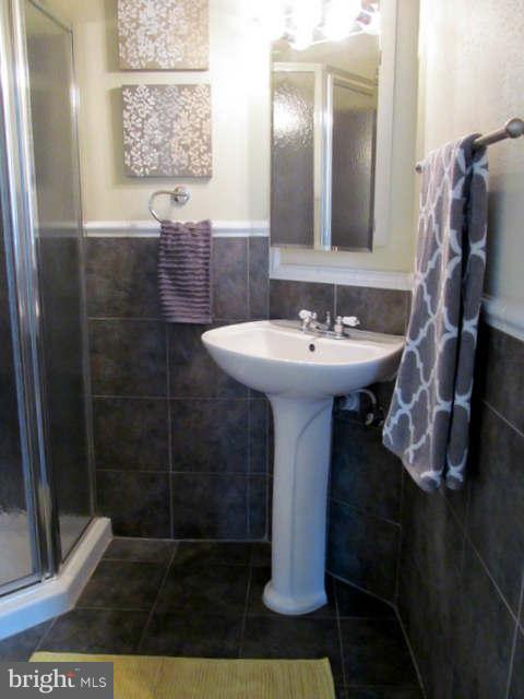 1908 6th Street Northwest Washington, DC 20001 - Photo 21 of 30 a bathroom with a sink a mirror and shower